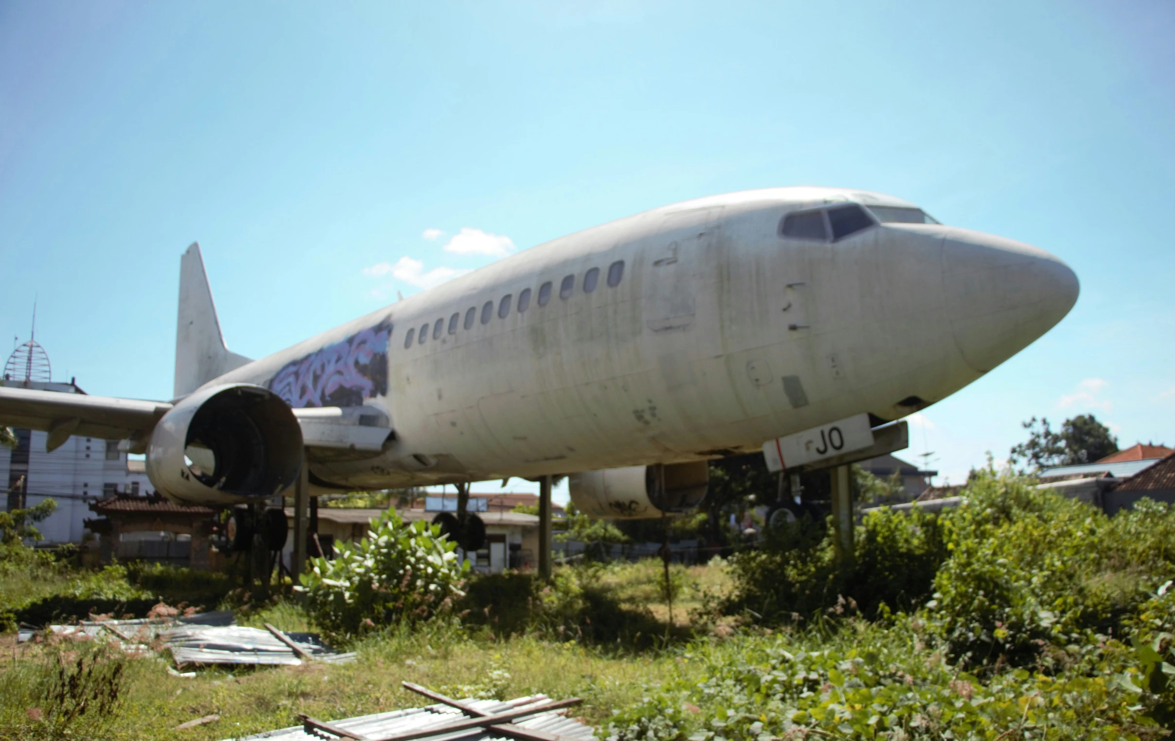 an airplane sits in the middle of the field