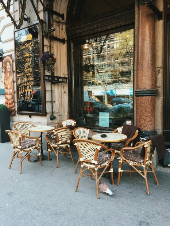 wicker patio furniture line the side of a store