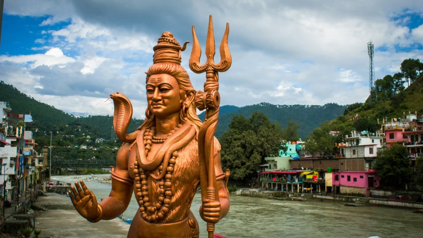 a statue is outside with some buildings in the background