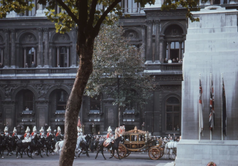 a carriage riding down a street surrounded by horses