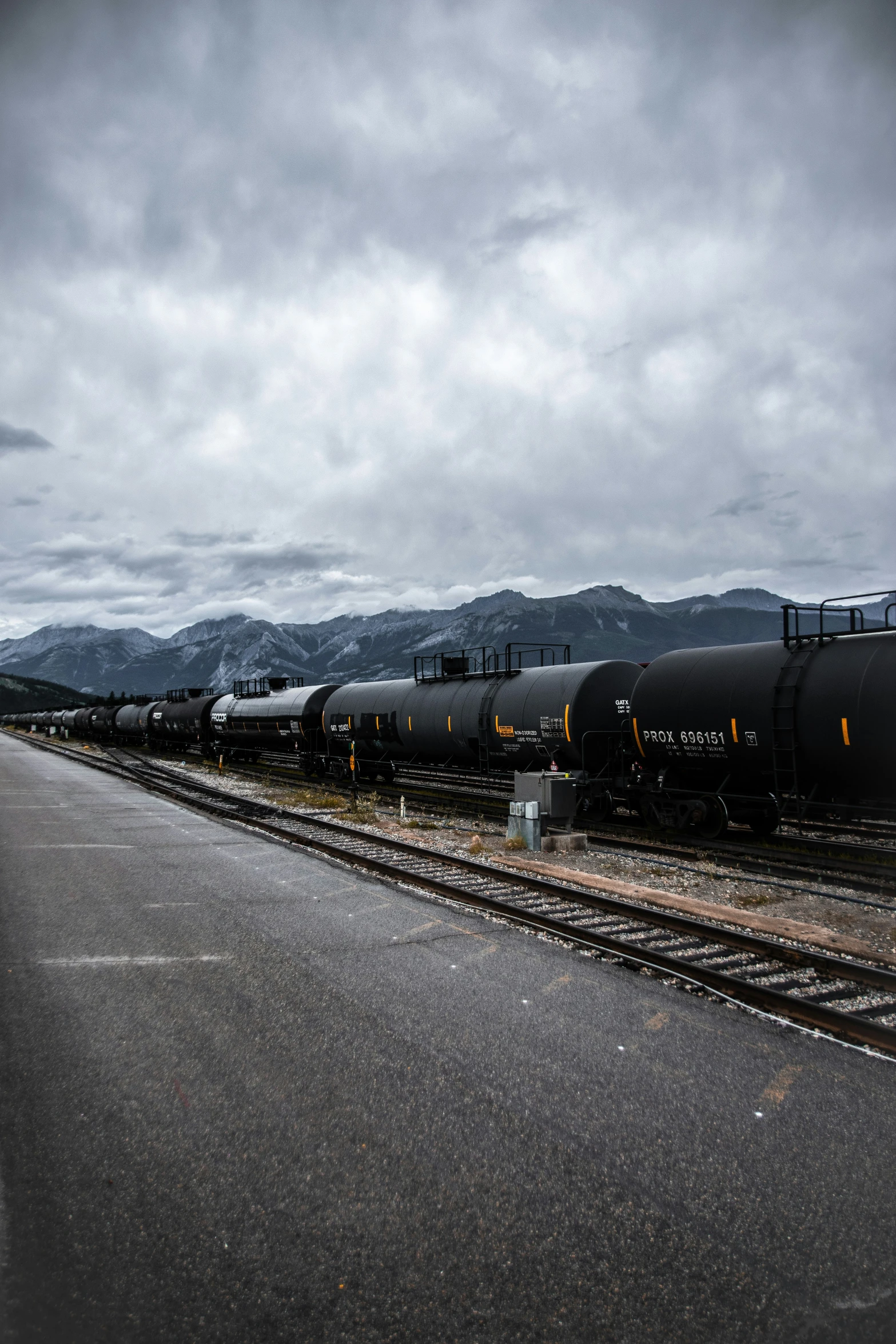 two trains sitting on train tracks in the snow