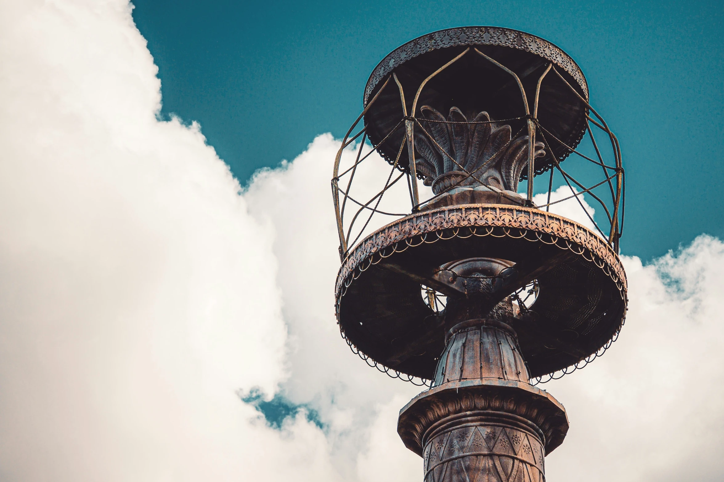 an old rusted, rusty looking tower with metal netting