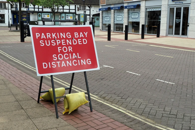 a red sign is displayed on a street corner