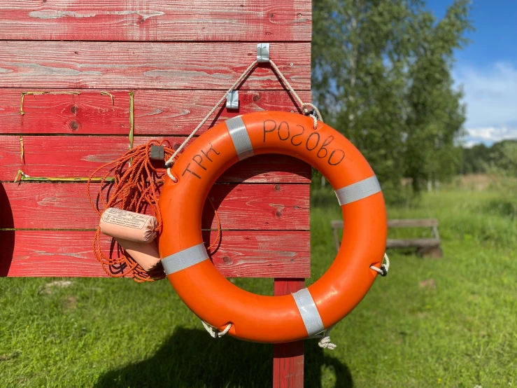 an orange life saver next to a wooden dock