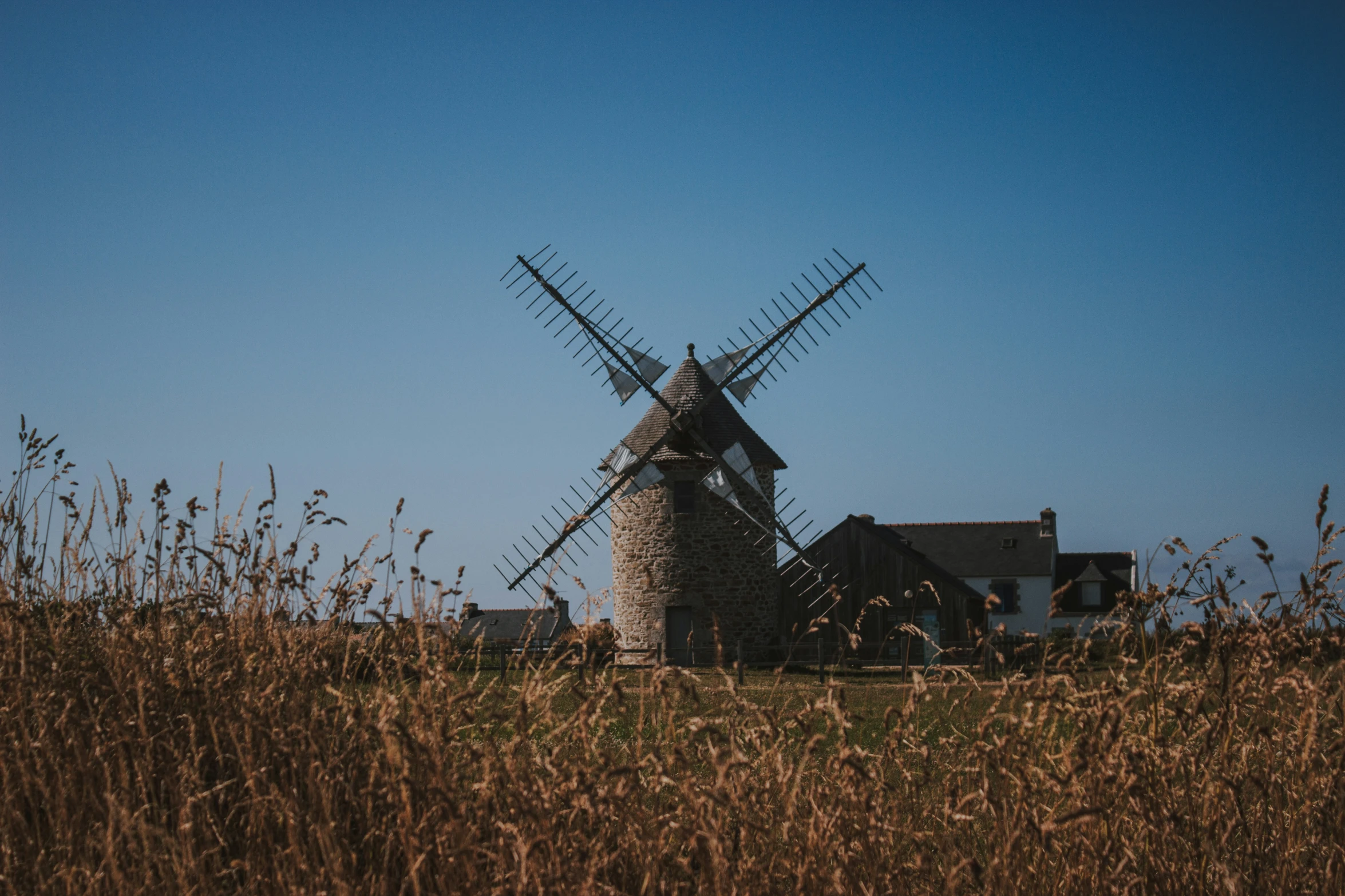 a po of a windmill in the fields