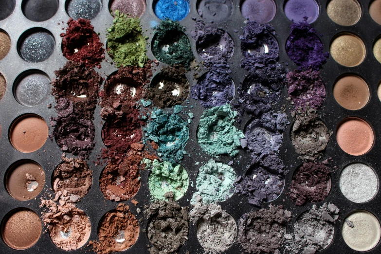 various colorful makeup colors with lids in an open container