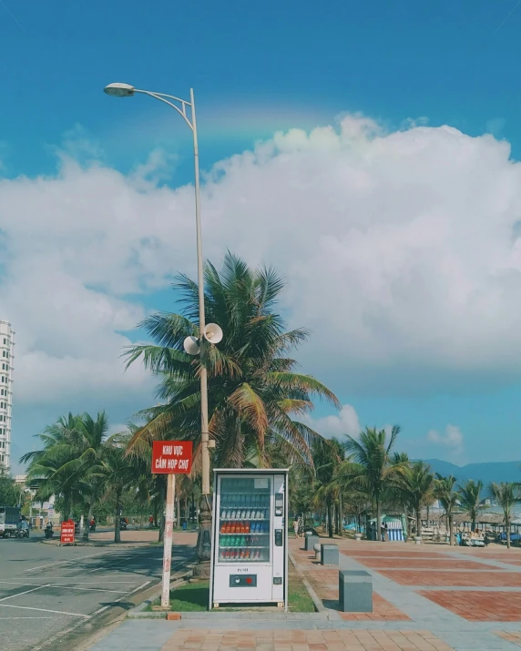 a street sign and telephone booth by a light post