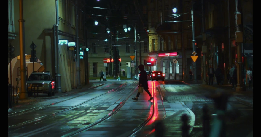 a man walking down a street at night