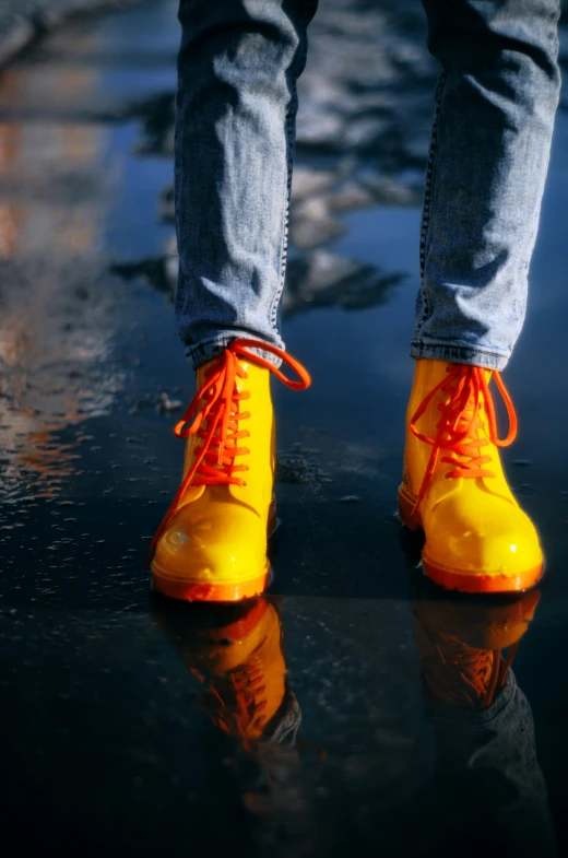 the legs of a person wearing yellow boots