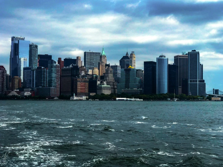 a group of buildings overlooking the water and a city