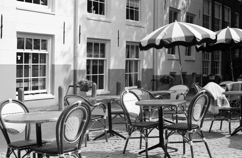 tables and chairs near umbrellas outside of the restaurant