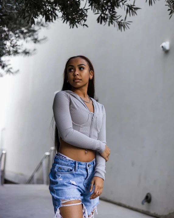 a woman in ripped shorts posing for the camera