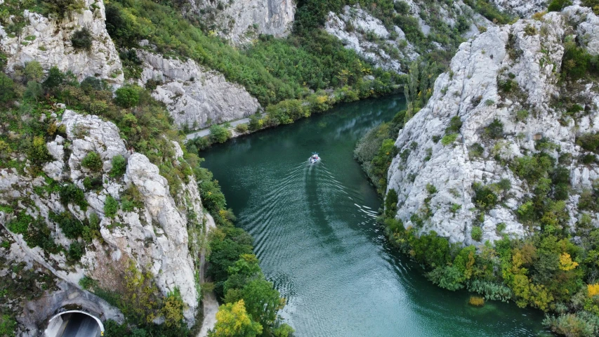 a boat is traveling through a narrow canyon