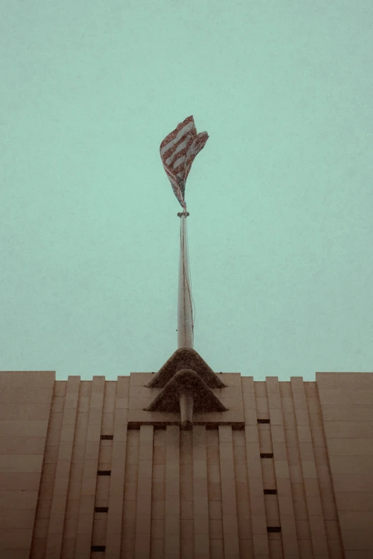 a big building with a tall flag hanging off the side