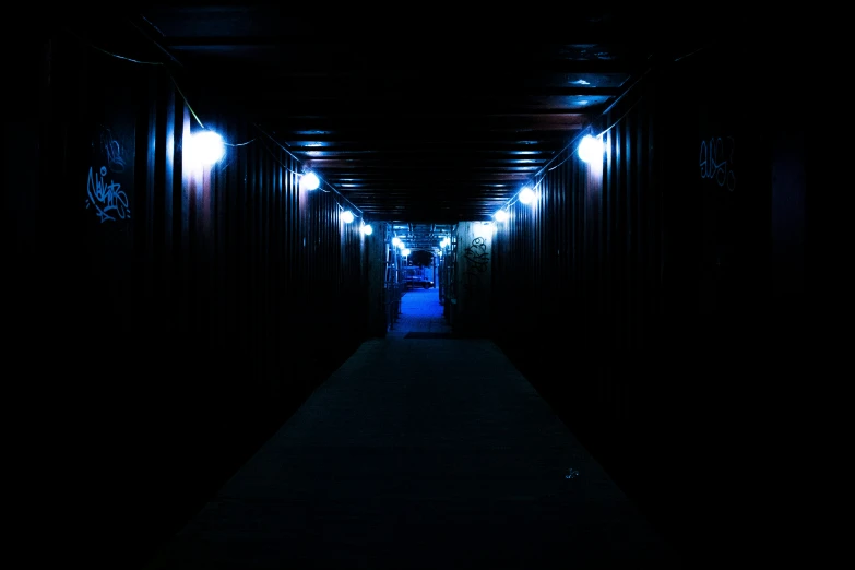 a long walkway going into a dark tunnel