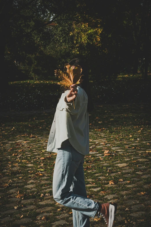 a person jumping in the air holding onto leaves