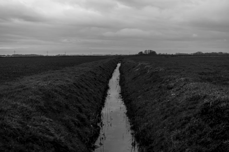 a long narrow ditch in the middle of a field