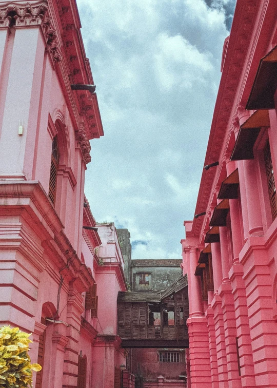 a street in an ancient european city with very pink buildings