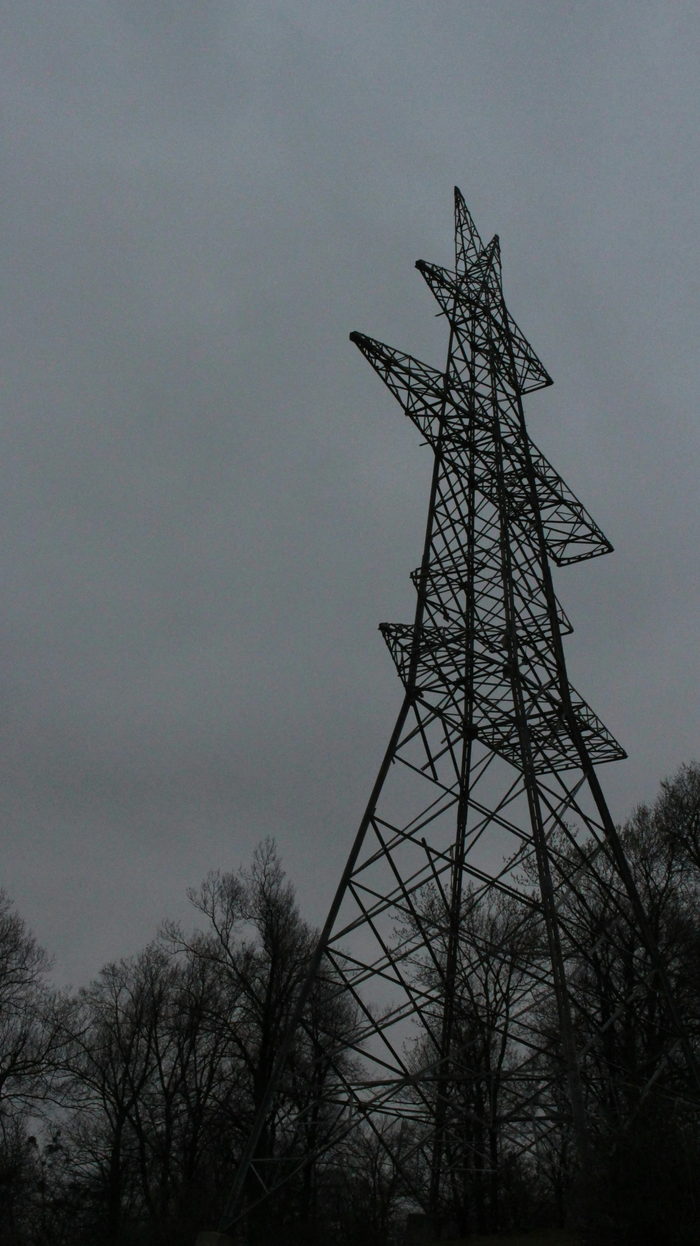 a tower on a hill covered in trees