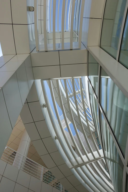 the top and bottom floors of a futuristic building with vertical glass