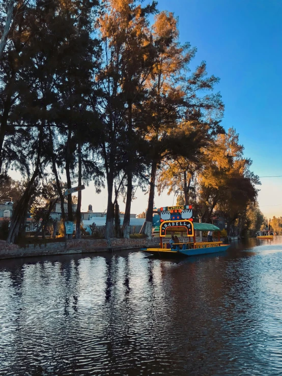 a school bus on the water with trees