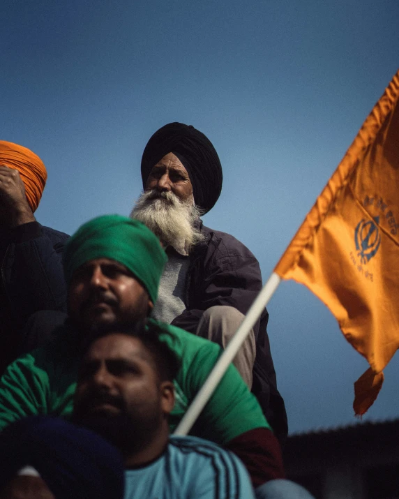 some men with beards holding yellow flags