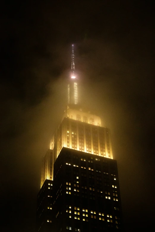 the building lights up as it sits in the sky