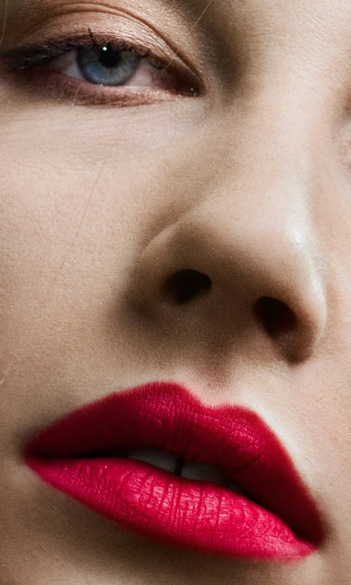 a woman's red lipstick can be seen as if the picture is blurred