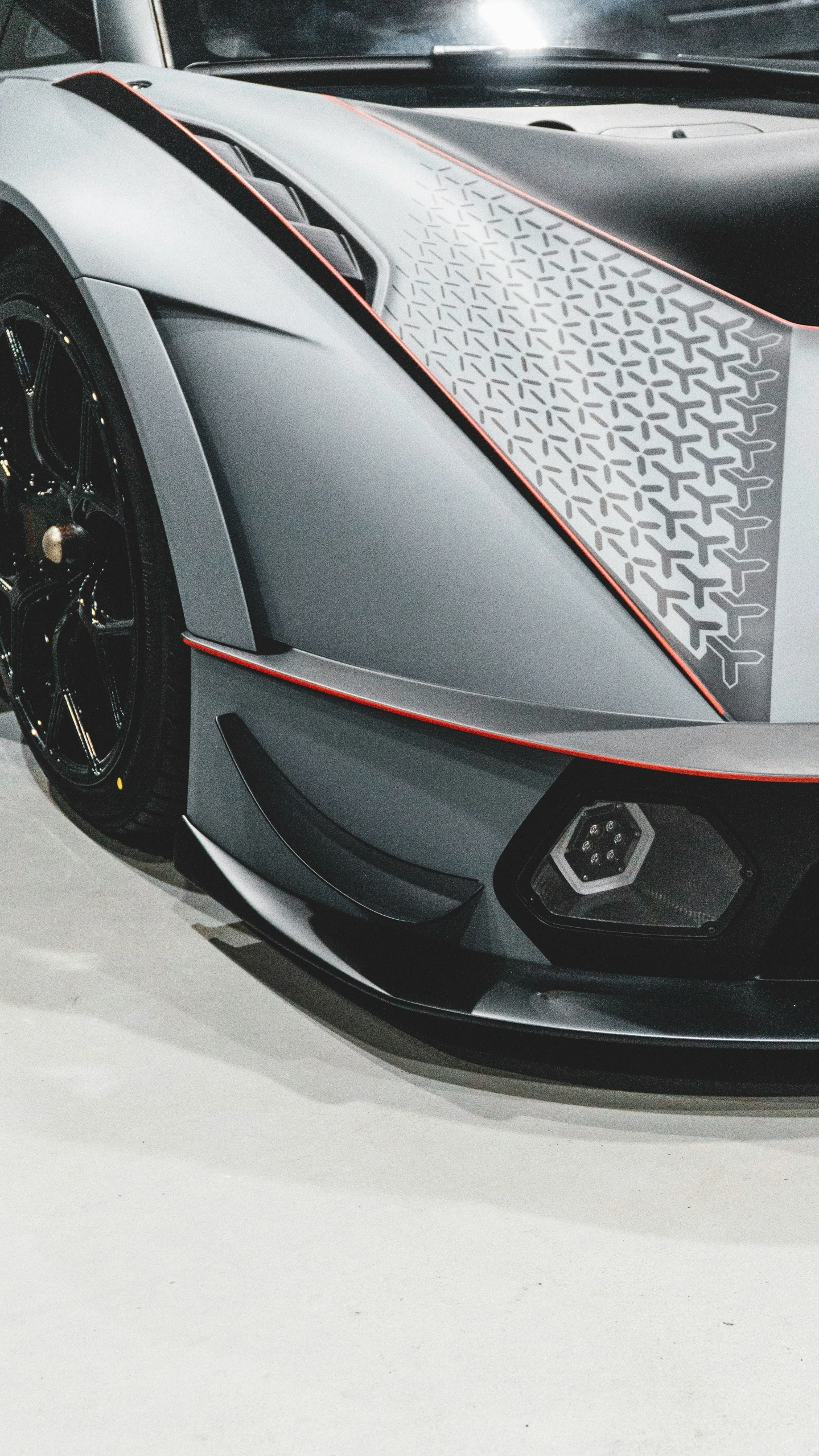 a close up view of a sports car, showing the hood and side vents