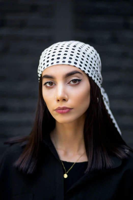 a model is shown with a large, straight headpiece