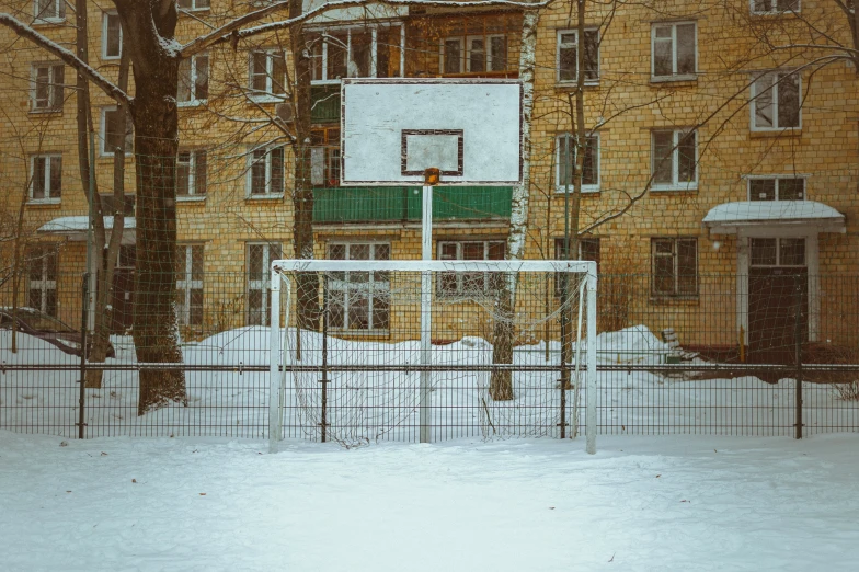 there is a fence surrounding the basketball goal