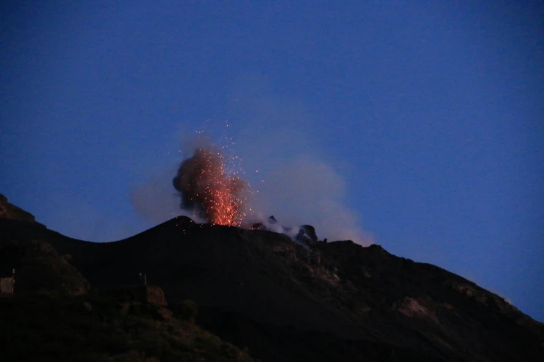 a fire has spews out of a chimney in the air