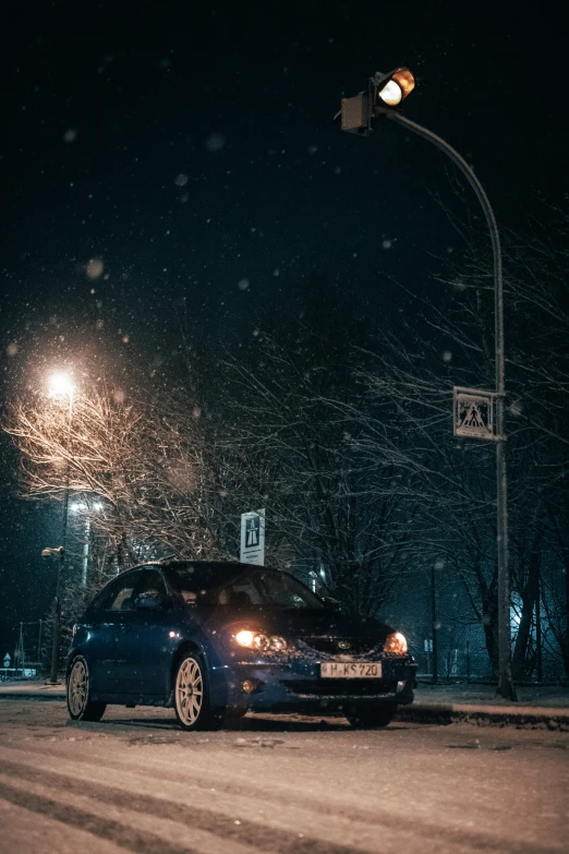 a car driving down the road in winter