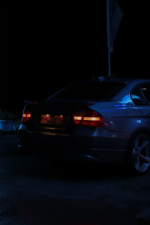 a gray car parked at night in the dark