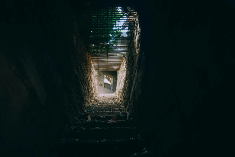 a very dark dark tunnel with a stair railing