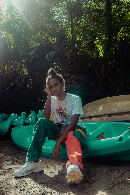 man sitting on an inflatable canoe, posing for a picture