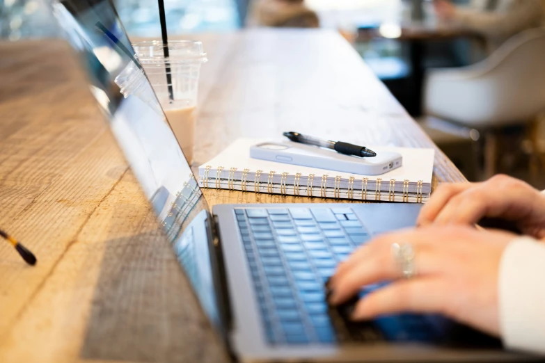 a person working on their laptop while at a restaurant