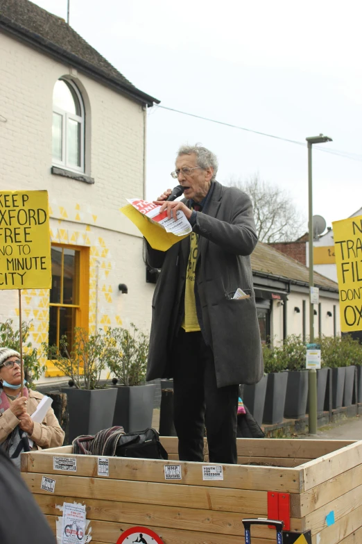 a man stands with a newspaper in his hands