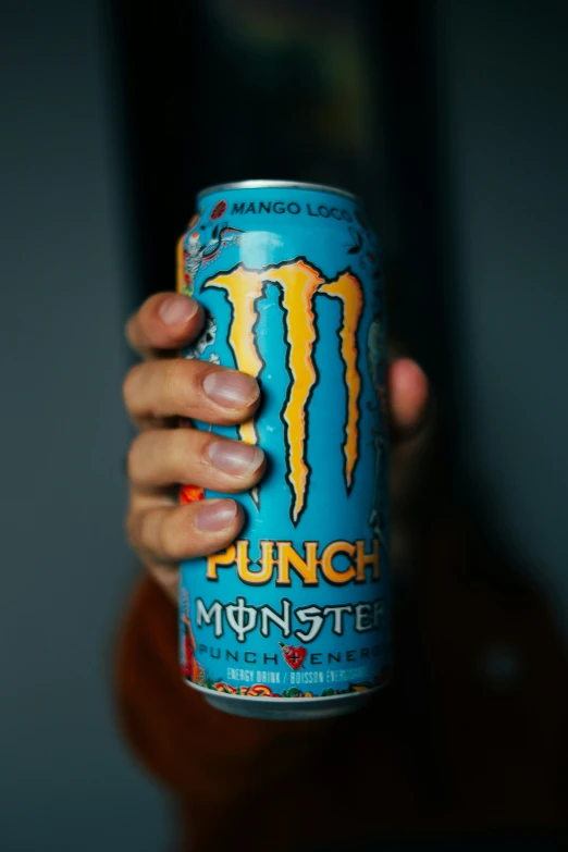 a person holding onto a monster energy drink
