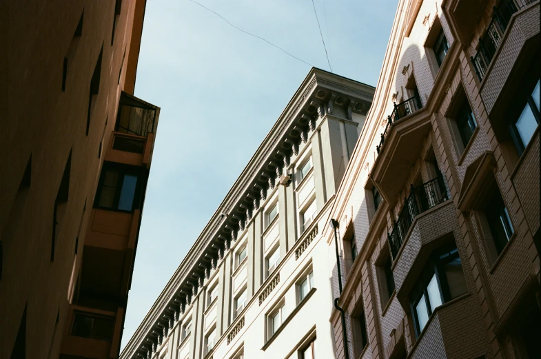 looking up at an old building and another building in the background