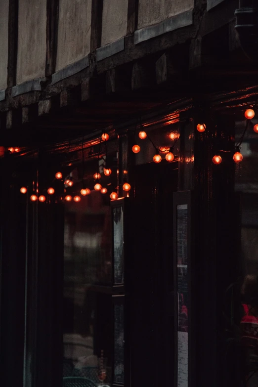 several red lit up lights in an old window