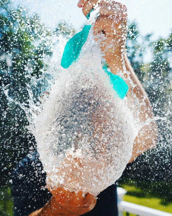 a man holding a surfboard under the water in his hands