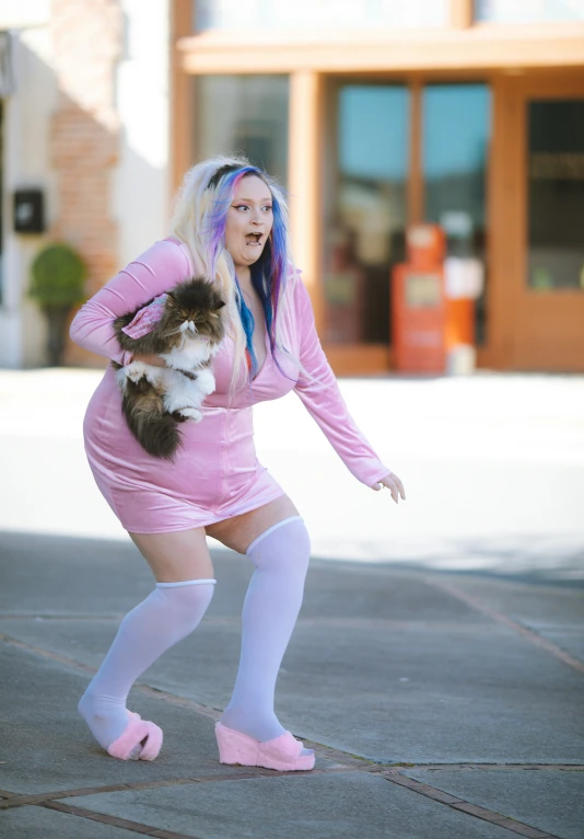 a woman in tights holding a cat on her lap