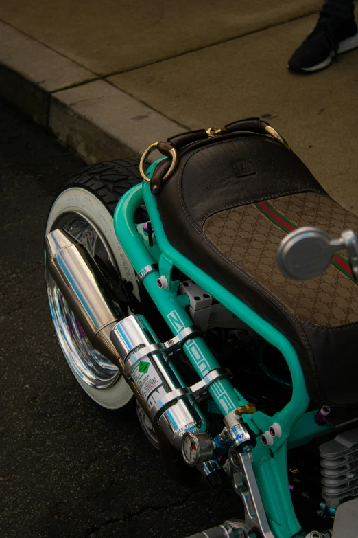 a small blue motorcycle parked on a city street