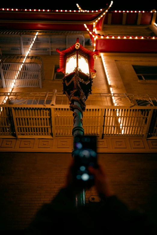 the lantern post is lit up with some lights on it