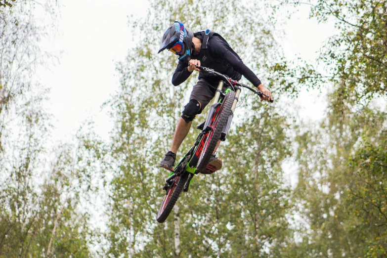 a man on a bike jumping into the air