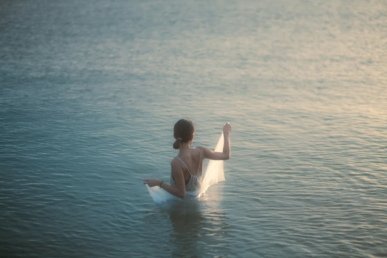 there is a woman that is sitting in the water