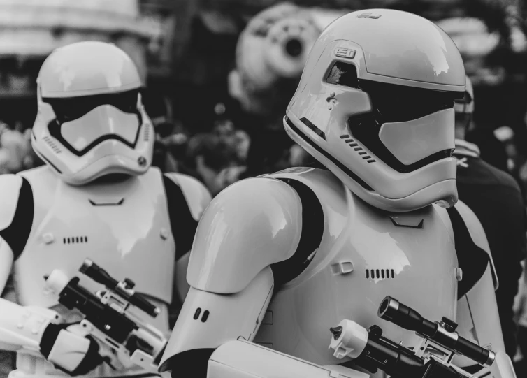 two storm troopers are holding guns and facing the camera