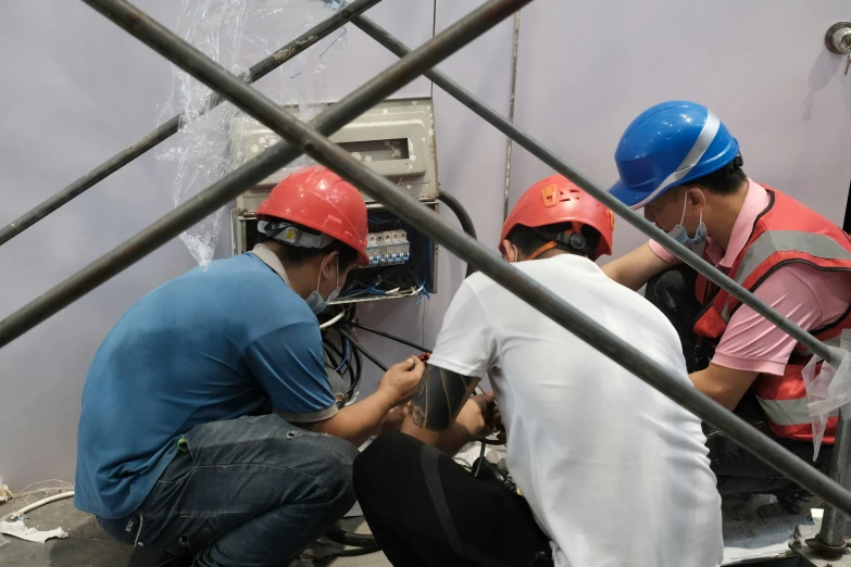 a couple of people wearing helmets in an electrical device