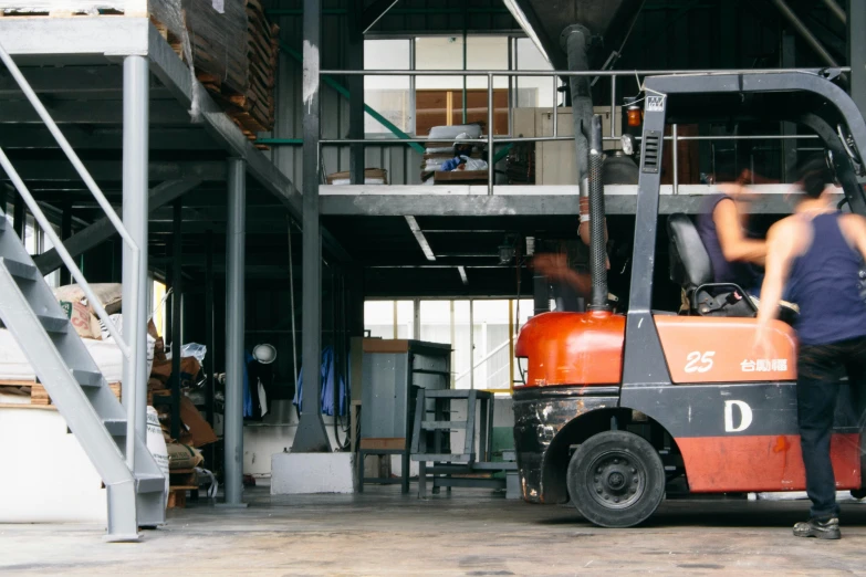 a fork lift truck in the warehouse moving furniture